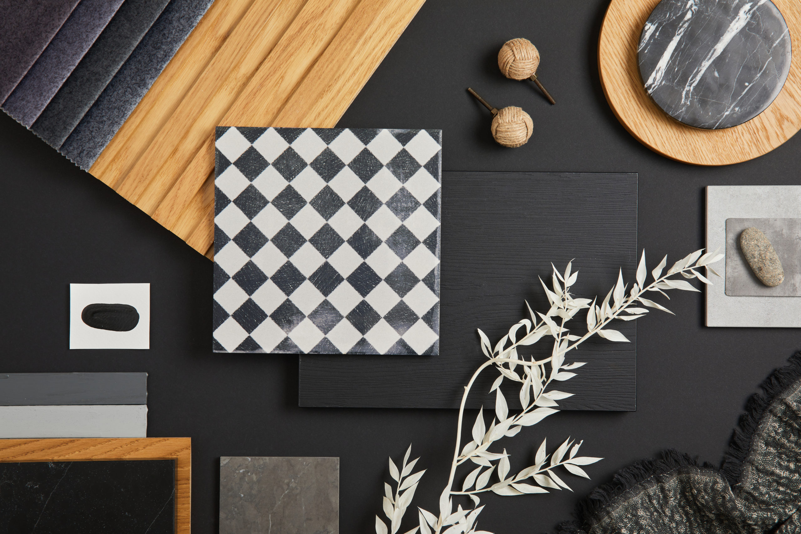 Stylish flat lay comosition of creative architect moodboard with black, white, beige and grey samples of textile, paint, wooden lamella panels and marble tiles. Top view. Copy space. Template.